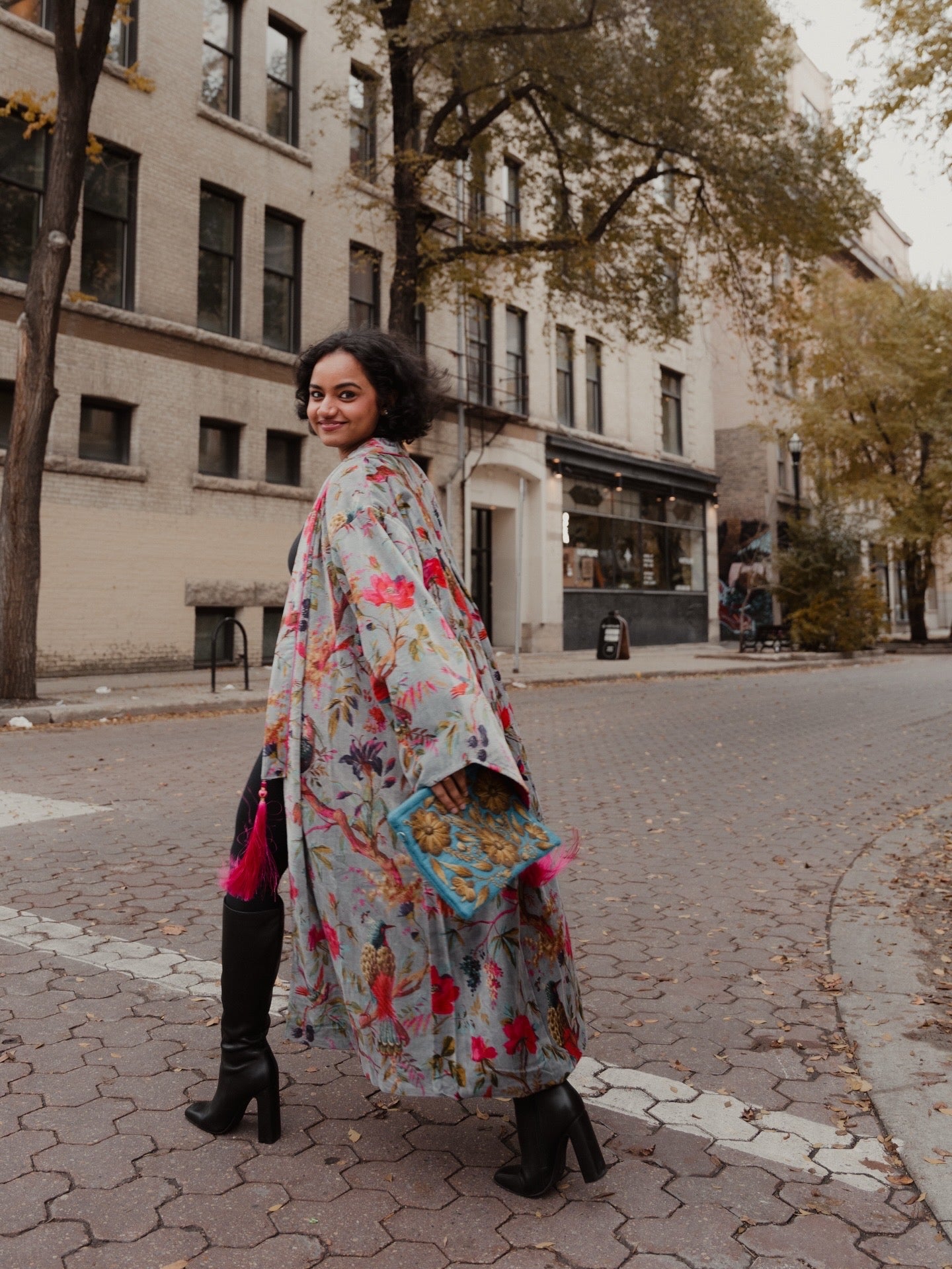 Woman in a floral dress standing on a city street